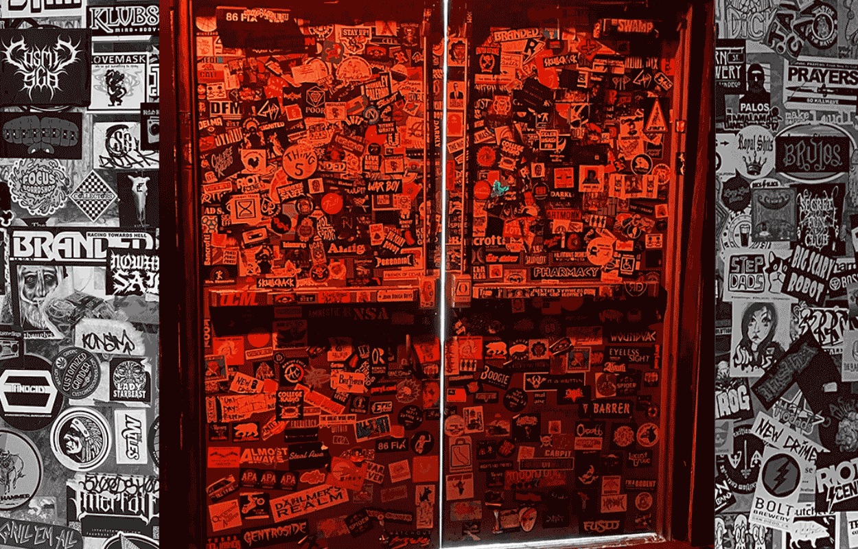 San Diego live music bar The Bancroft Bar featuring doors covered in band stickers and posters