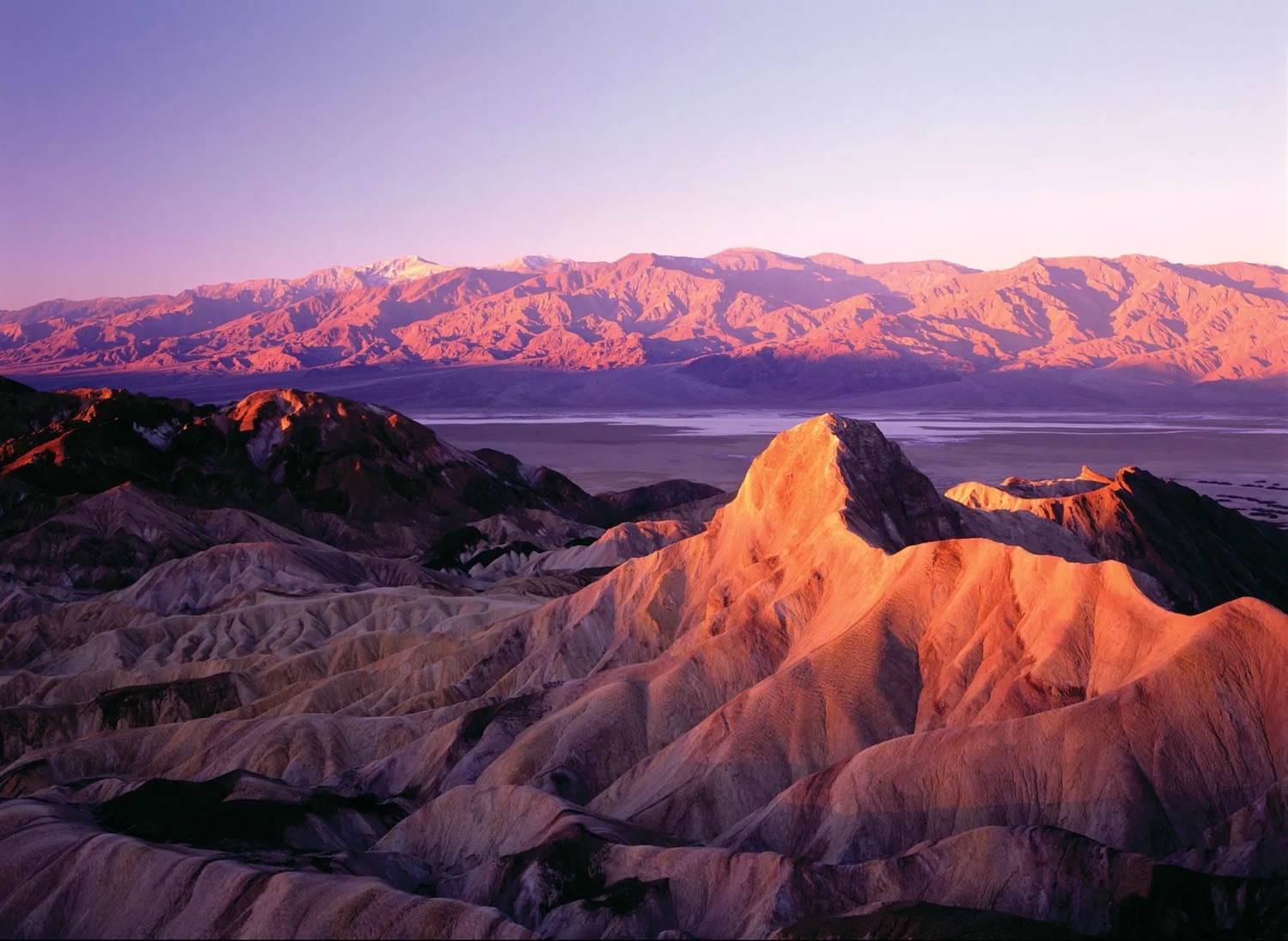 Guide to visiting California's national parks featuring Death Valley National Park at sunset